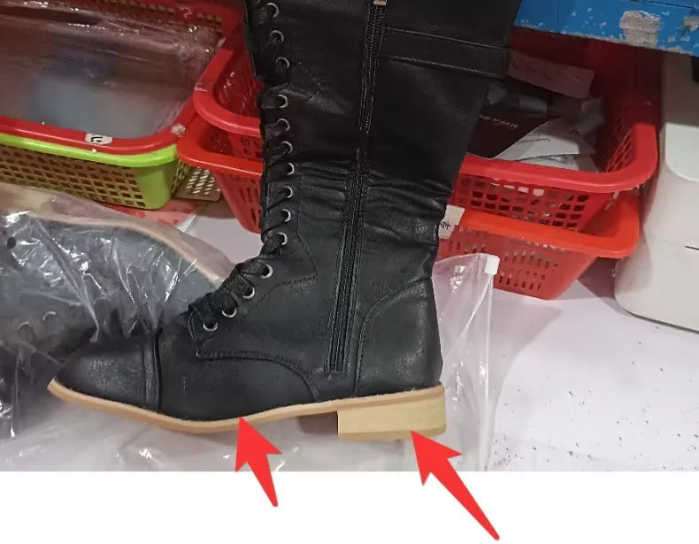 Women's black artificial PU knight boots with cross strap and lace-up closure on a size label.
