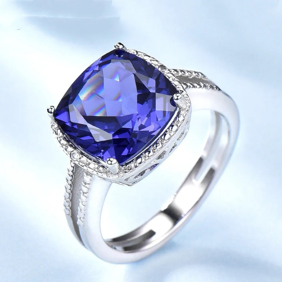Blue Tanzanite gemstone sterling silver ring on white background showing band detail
