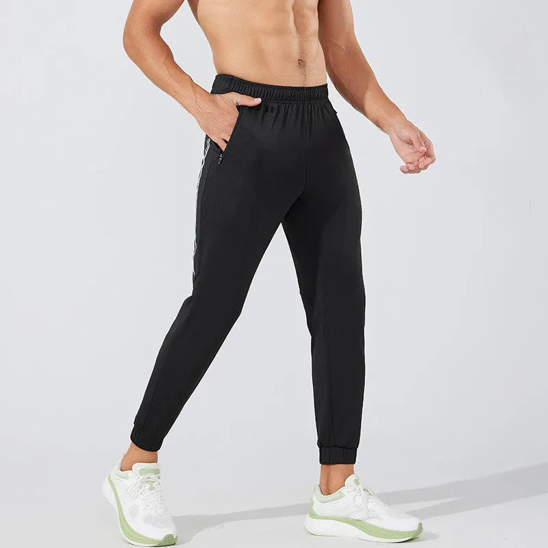 Men's black running trousers with mid waist design and polyester fabric for exercise