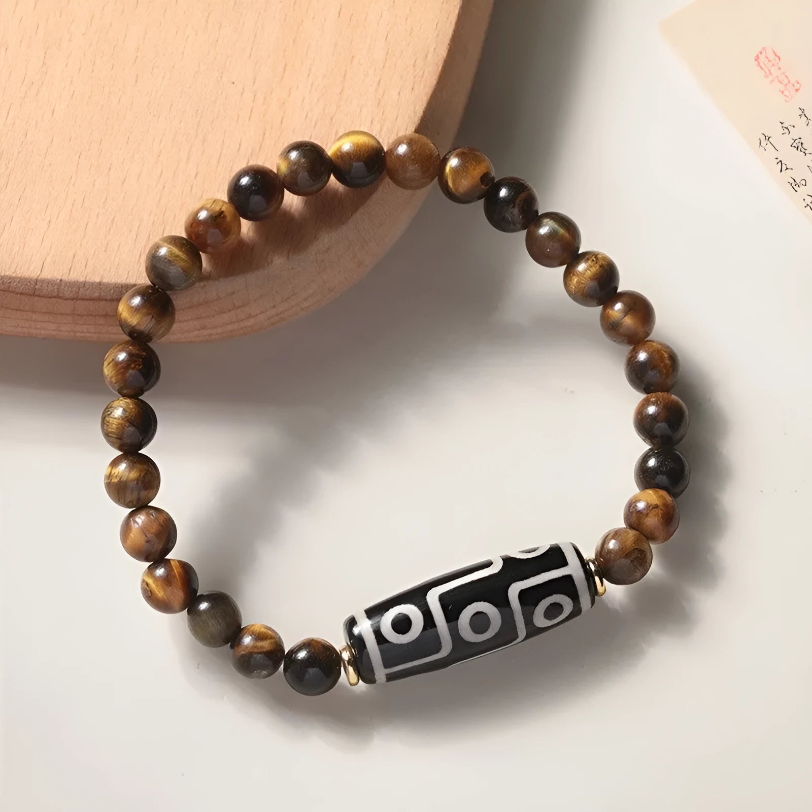 Ethnic style tigereye Dzi bead simplicity Buddha rosary bracelet on display with multiple bead sizes