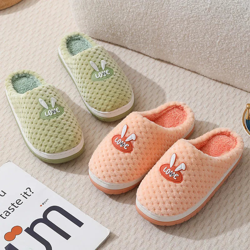 Women's rabbit plaid design artificial fur house slippers with a thick non-slip rubber sole.