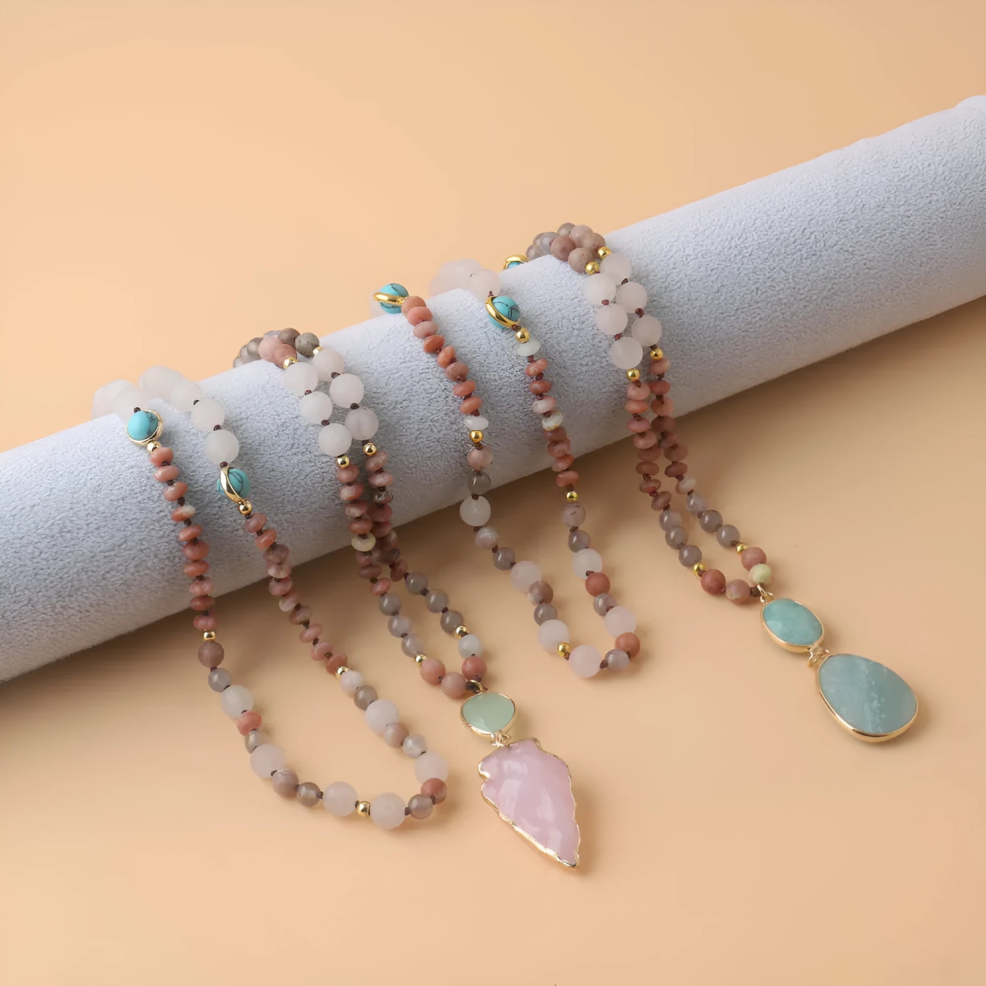 Unisex natural stone beaded necklace with round beads in pink and green colour options on white background