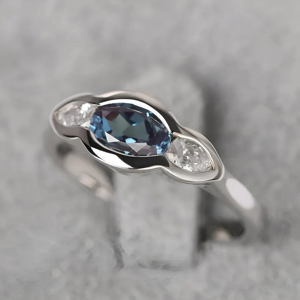 Geometric ellipse ring with inlaid zircon stones in white gold colour finish