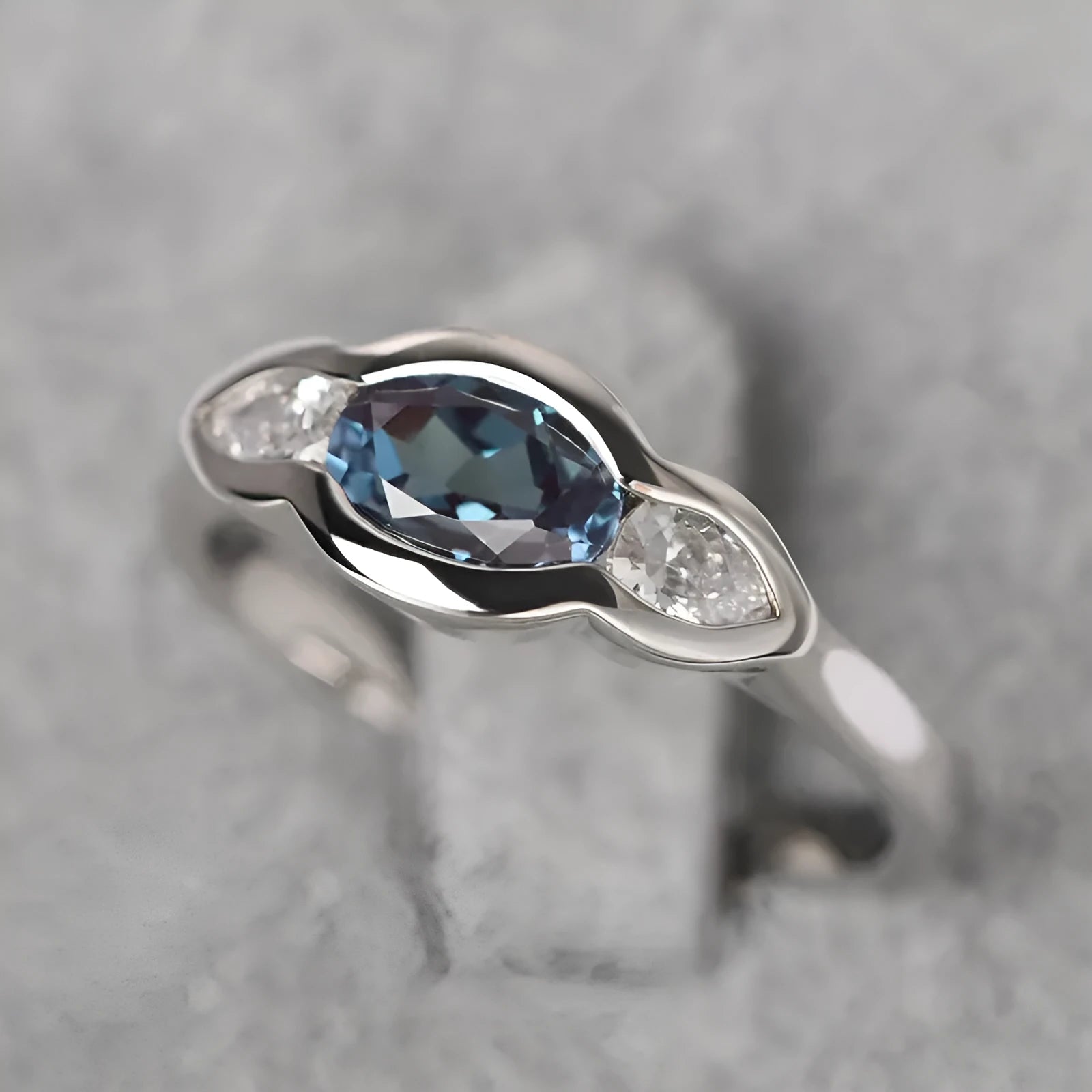 Geometric ellipse ring with inlaid zircon stones in white gold colour finish