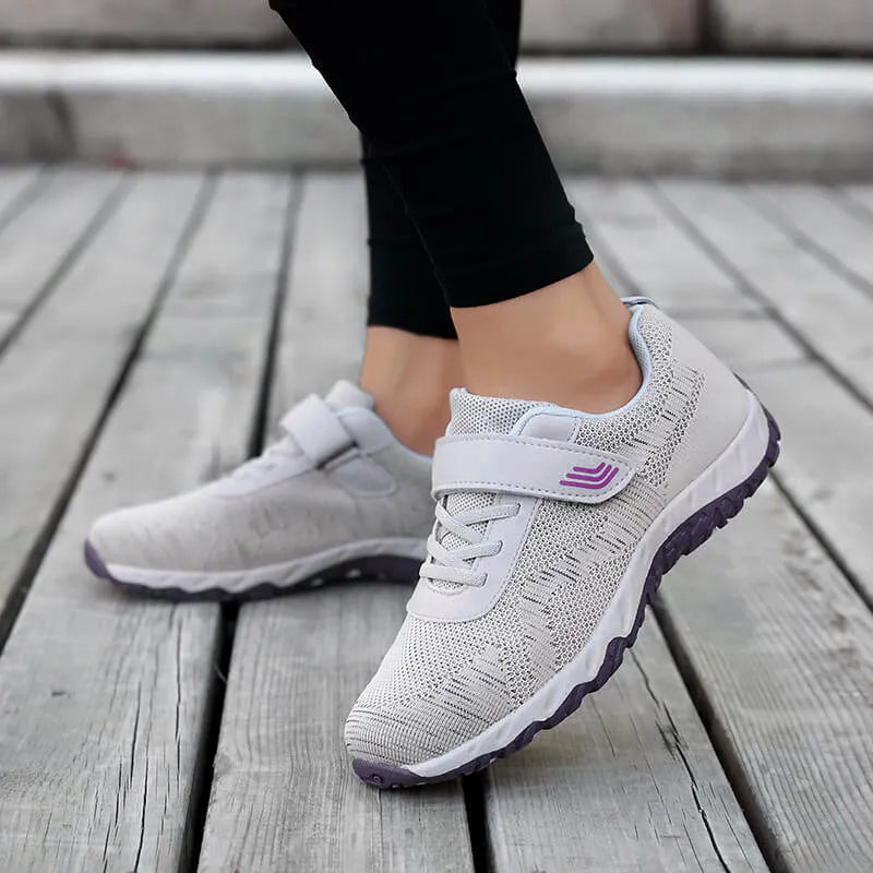 Women's grey purple wedge shoes with Velcro strap and mesh upper on a composite sole.