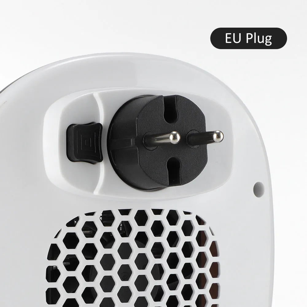 White ceramic electric heater with remote control on a table.