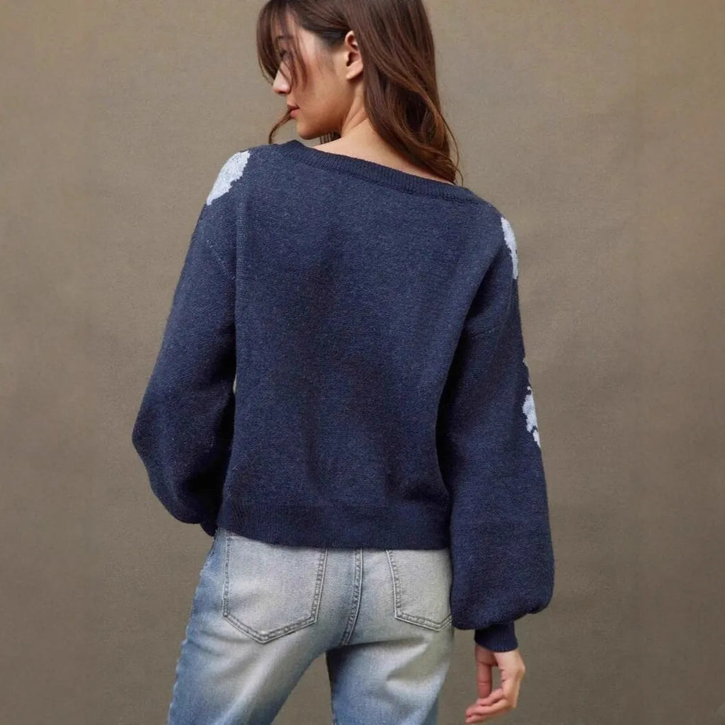 Women's loose-fit sapphire blue pullover with white flower jacquard pattern and long sleeves.