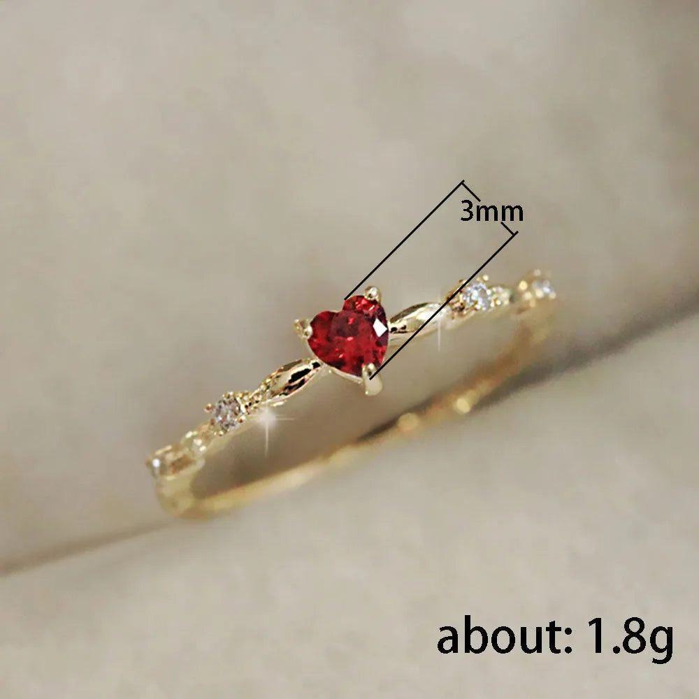 Copper zircon peach heart ring in gold on hand, unisex size
