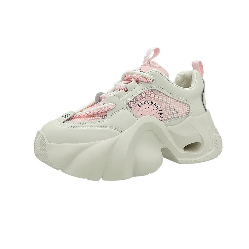 Women's pink casual sneakers with cross shoulder straps, thick sole, and mesh lining on a white background.