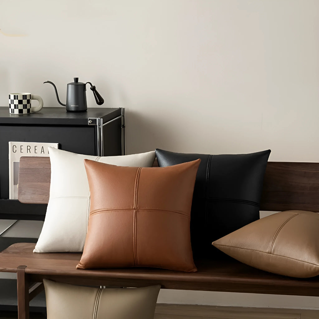 Soft cowhide leather pillow cover in a solid colour, shown in a Nordic-style room setting.