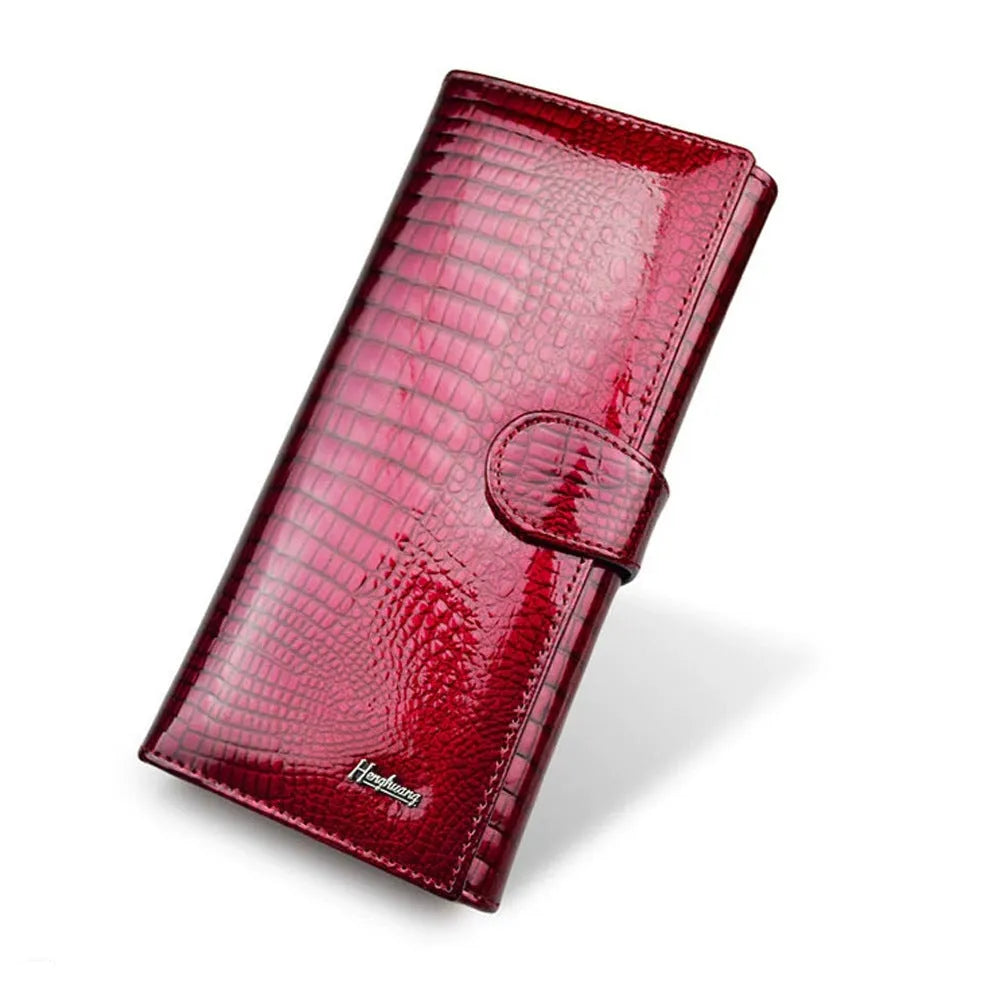 Women's patent leather coin purse with crocodile pattern in red colour showing pigskin lining interior