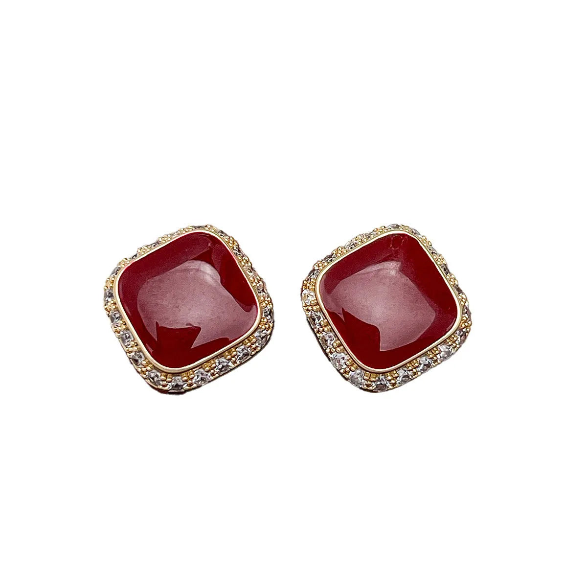 A pair of red geometric square alloy earrings with inlaid detailing on a white background.