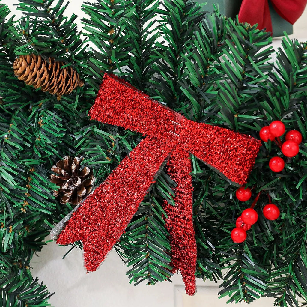 Christmas rattan wreath decoration with pine cones and red bow on green background