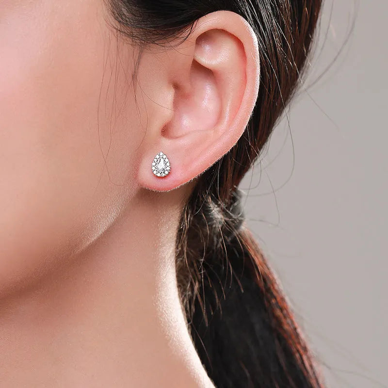 Silver drop-shaped ear studs with diamond-cut surface detail on 925 sterling silver