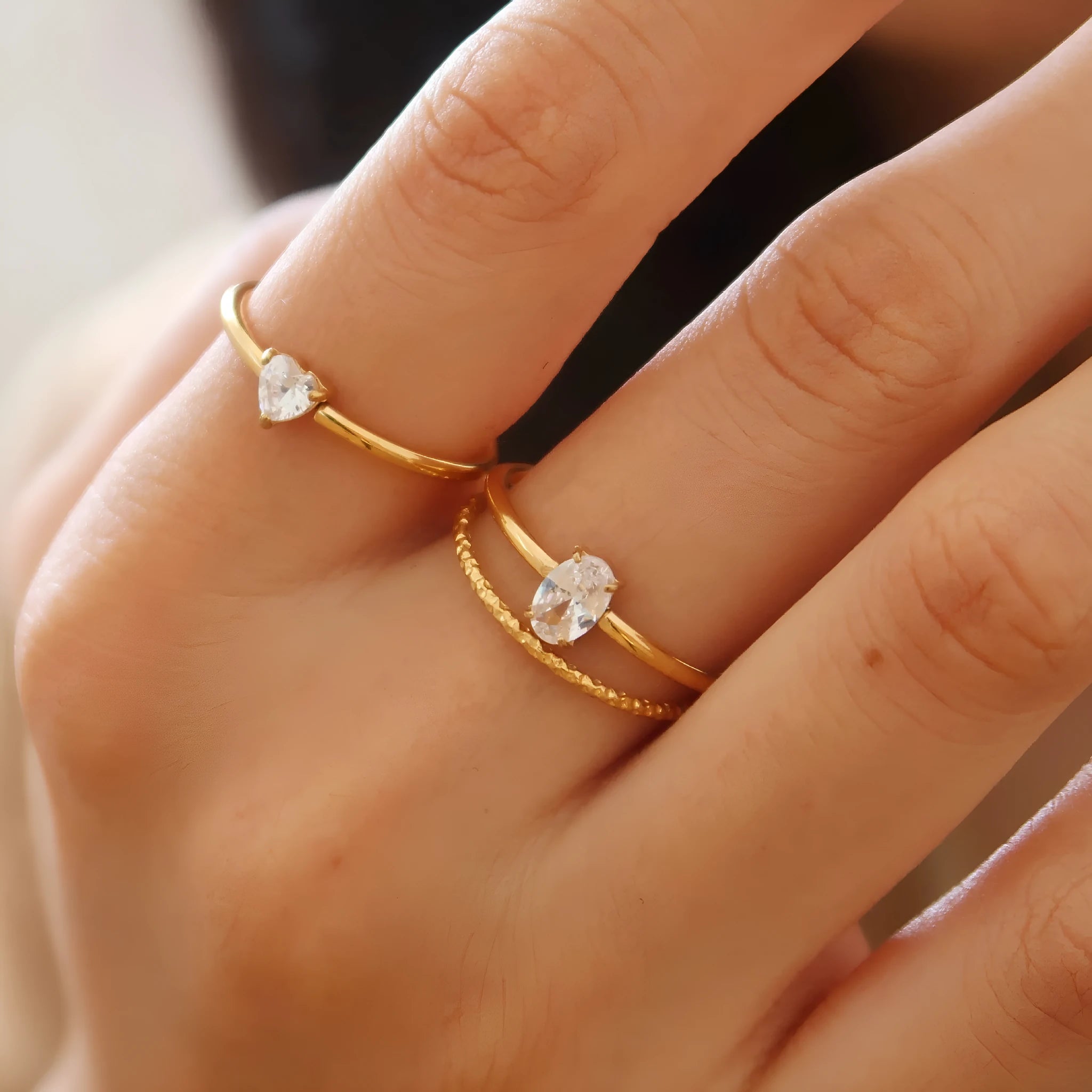 Golden heart shape stainless steel ring with electroplated finish on female hand