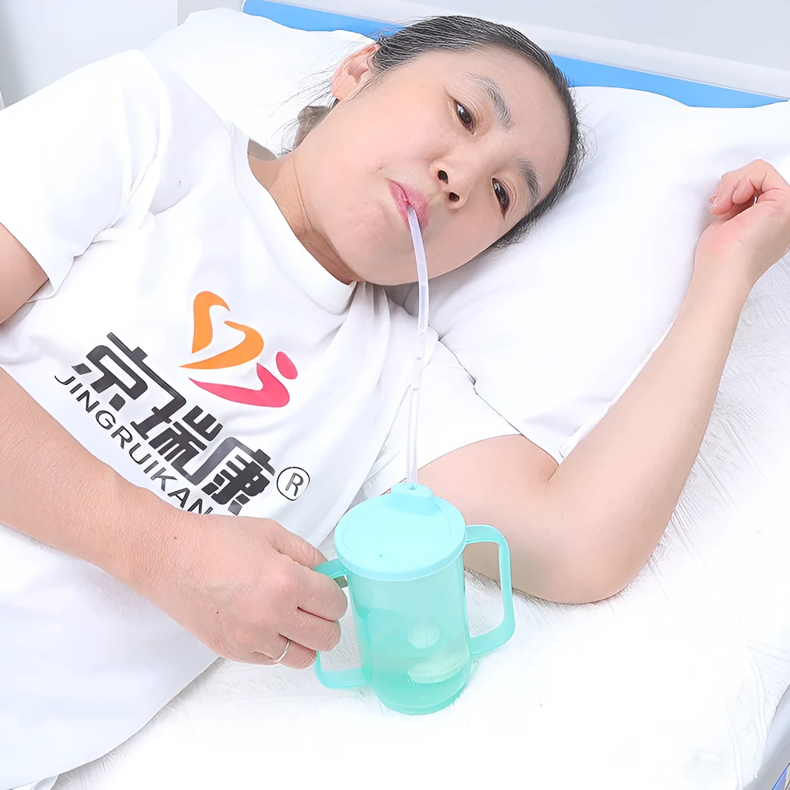 Angled mouth choke-proof bedside drinking cup with handle and lid, shown in PP plastic.