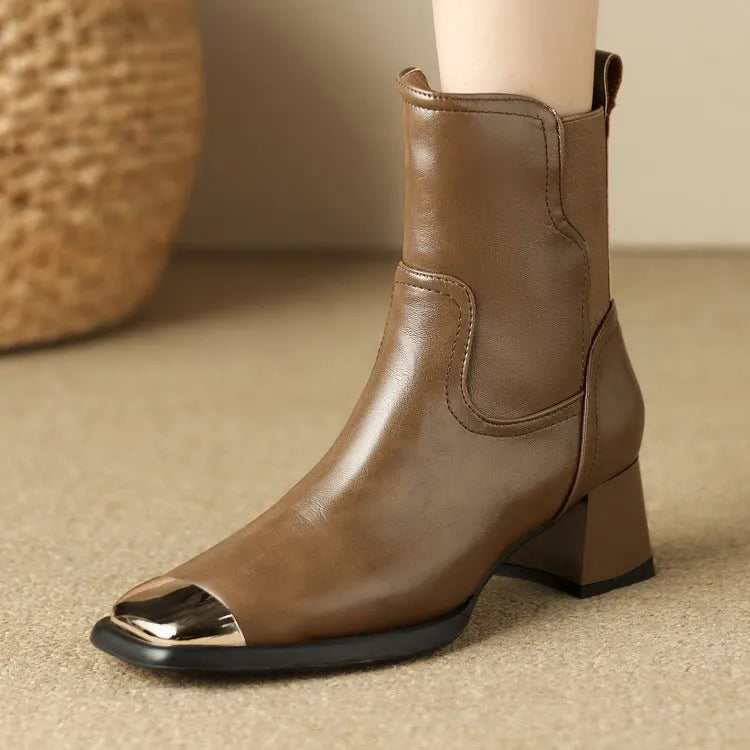 Brown women's cowhide leather Martin boots with a high heel and side zipper on a white background.