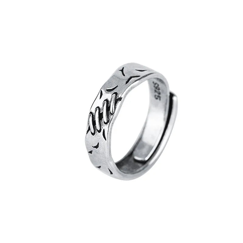 Black copper geometric adjustable ring with round and oval shapes on a white background