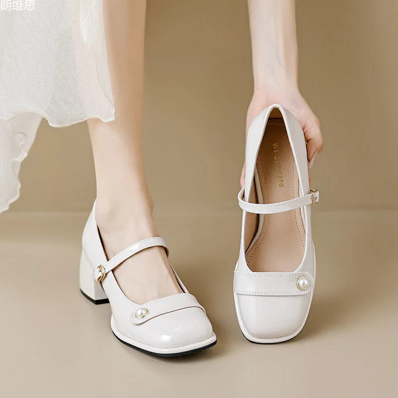 Apricot-coloured plus size hiking boots with a chunky heel, patent leather upper, and buckle fastening.
