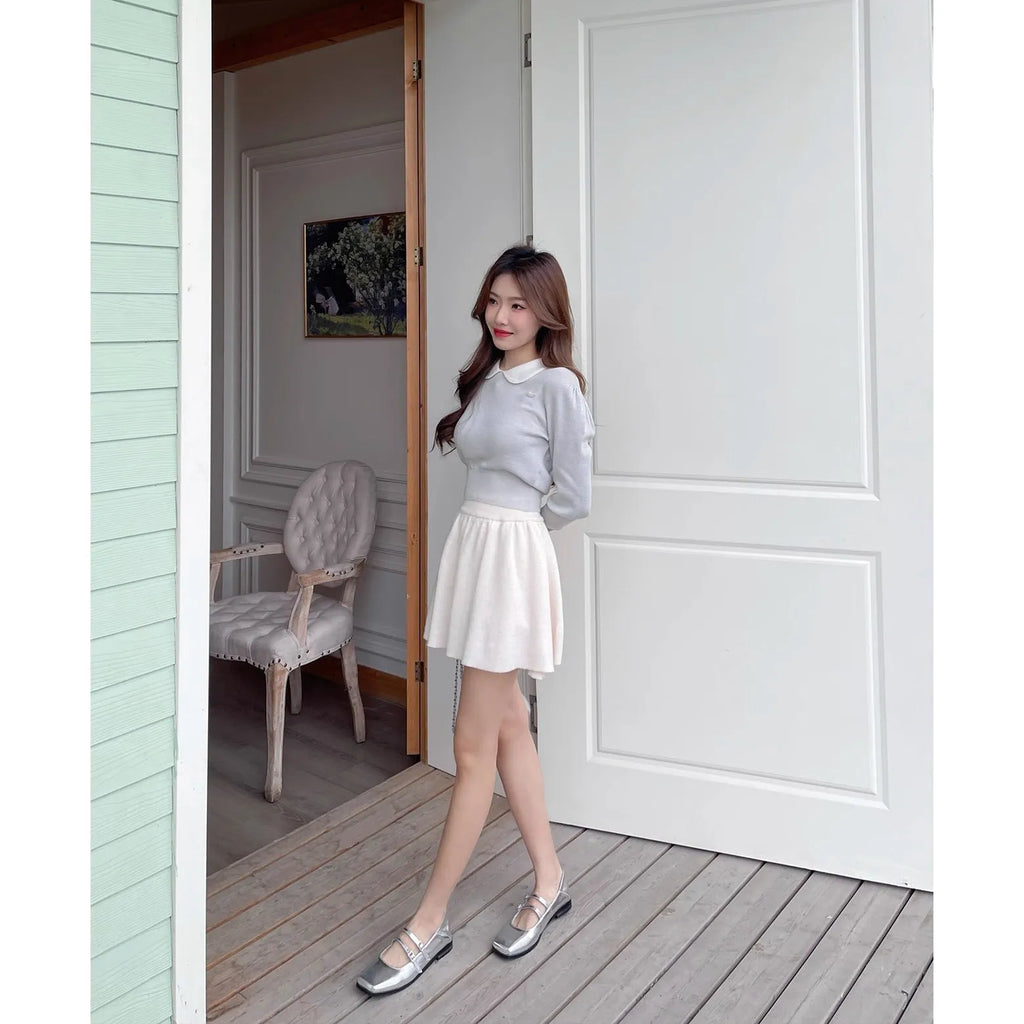 Women's silver leather ballet flats with a cross buckle strap, round toe, and low flat heel.