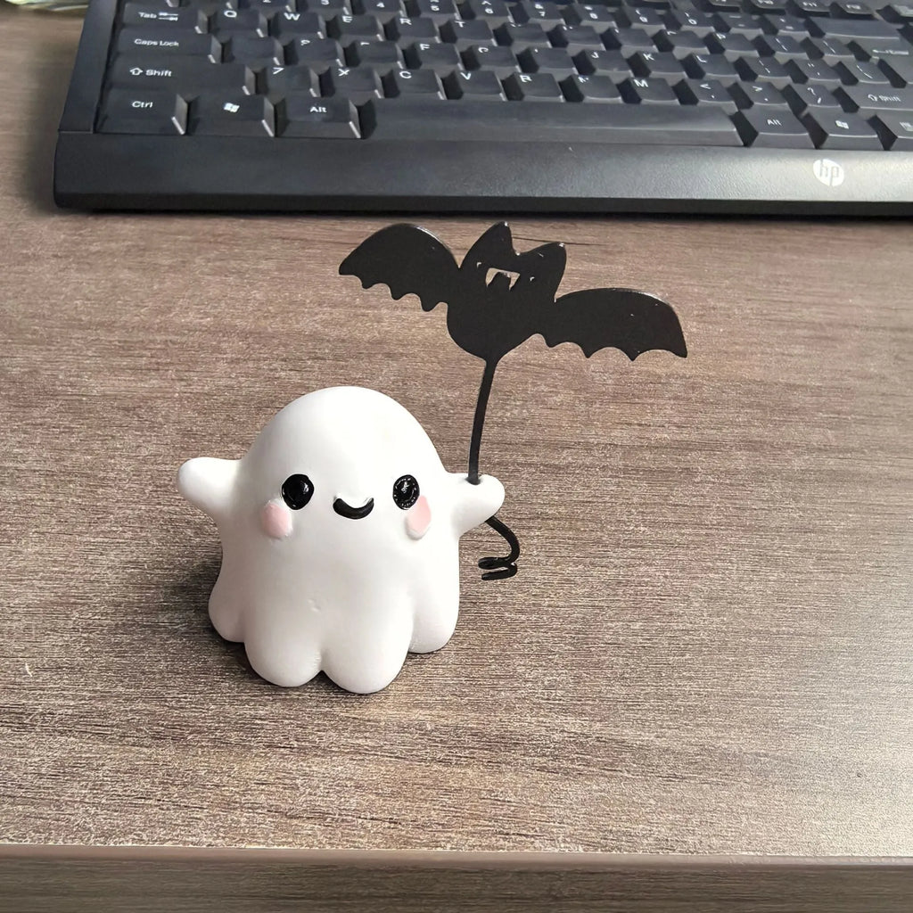 Miniature resin statue of a ghost walking a dog, Halloween decoration measuring 4x5x4cm.
