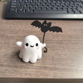 Miniature resin statue of a ghost walking a dog, Halloween decoration measuring 4x5x4cm.