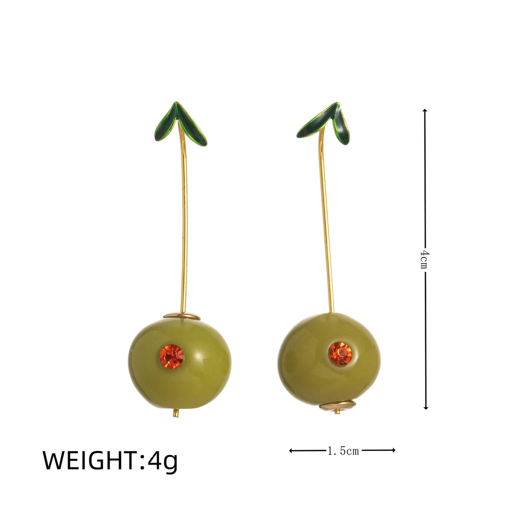 Gold plated copper earrings featuring fruit and vegetable shapes in multiple colours on display