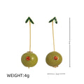 Gold plated copper earrings featuring fruit and vegetable shapes in multiple colours on display