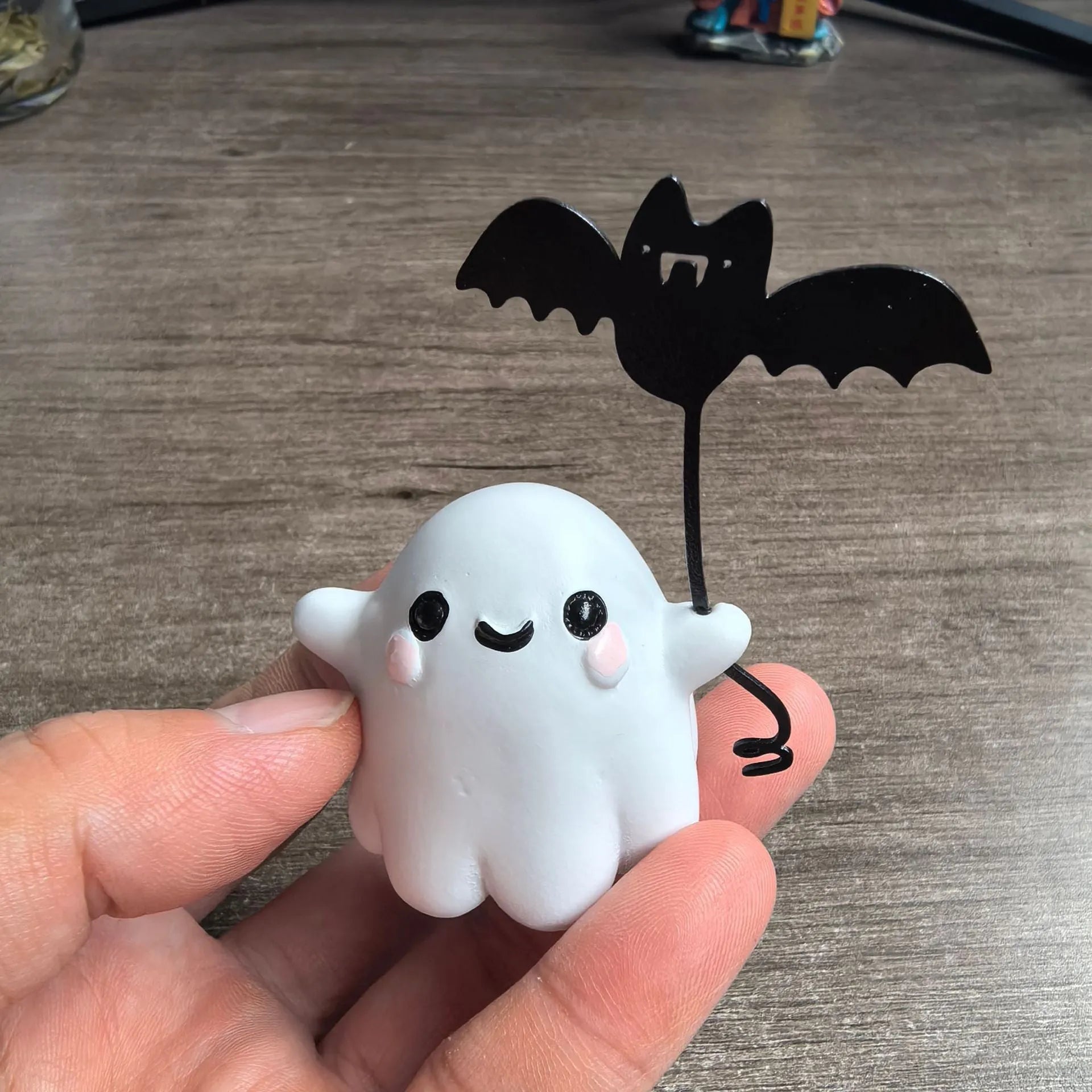 Miniature resin statue of a ghost walking a dog, Halloween decoration measuring 4x5x4cm.