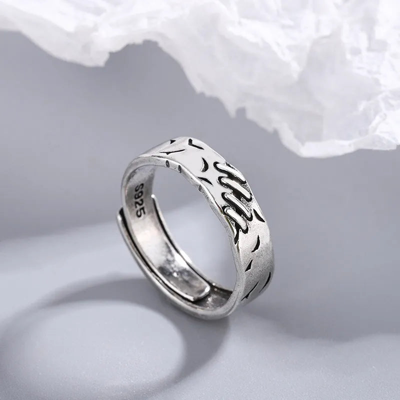 Black copper geometric adjustable ring with round and oval shapes on a white background