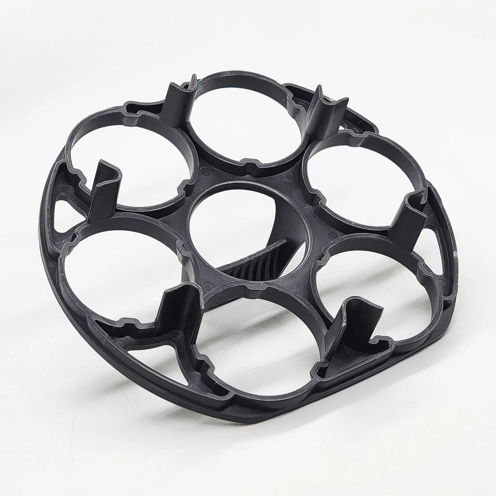 Modern black plastic egg holder tray measuring 13.8 by 12.6 by 5.7 centimetres on a kitchen counter.