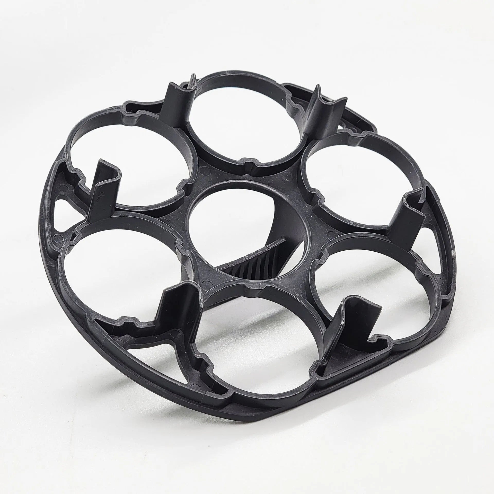 Modern black plastic egg holder tray measuring 13.8 by 12.6 by 5.7 centimetres on a kitchen counter.