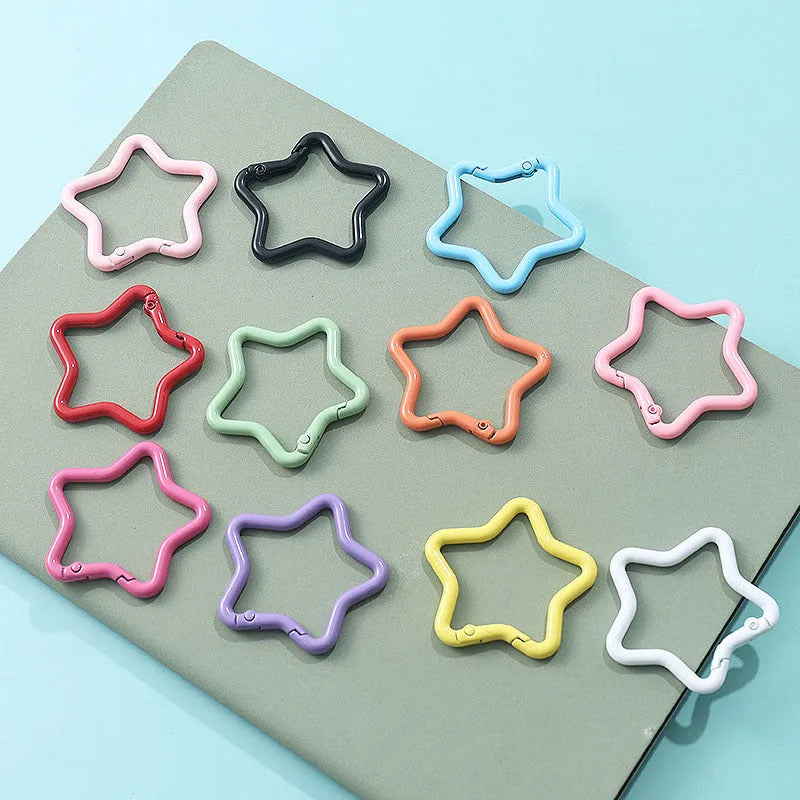 Zinc alloy five-pointed star keychain charm in multiple colour options on a keyring.
