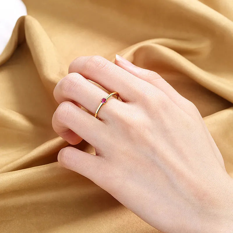 Copper geometric circle ring for women featuring a single central diamond, shown in blue.