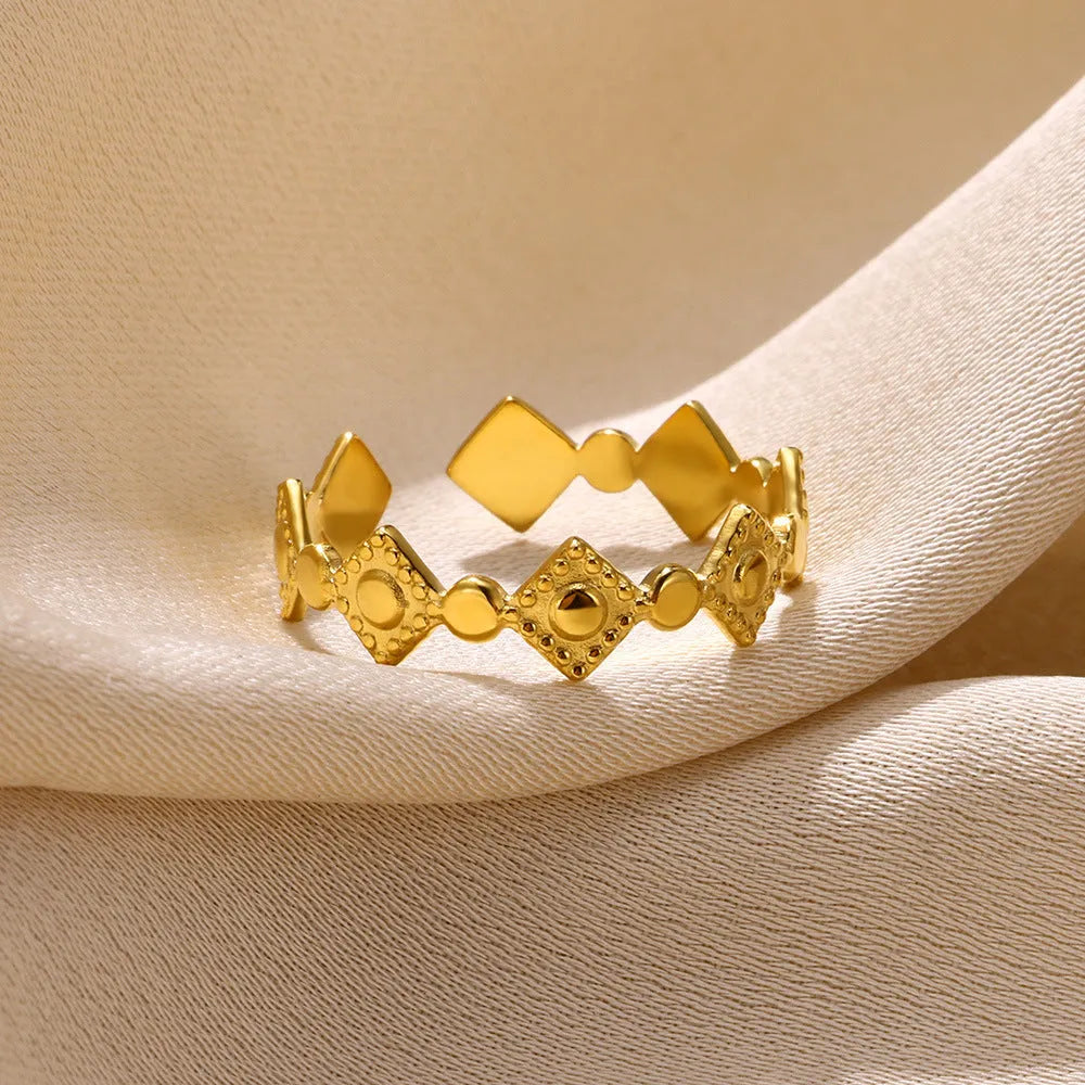 Geometric titanium steel women's ring with gold diamond setting on finger