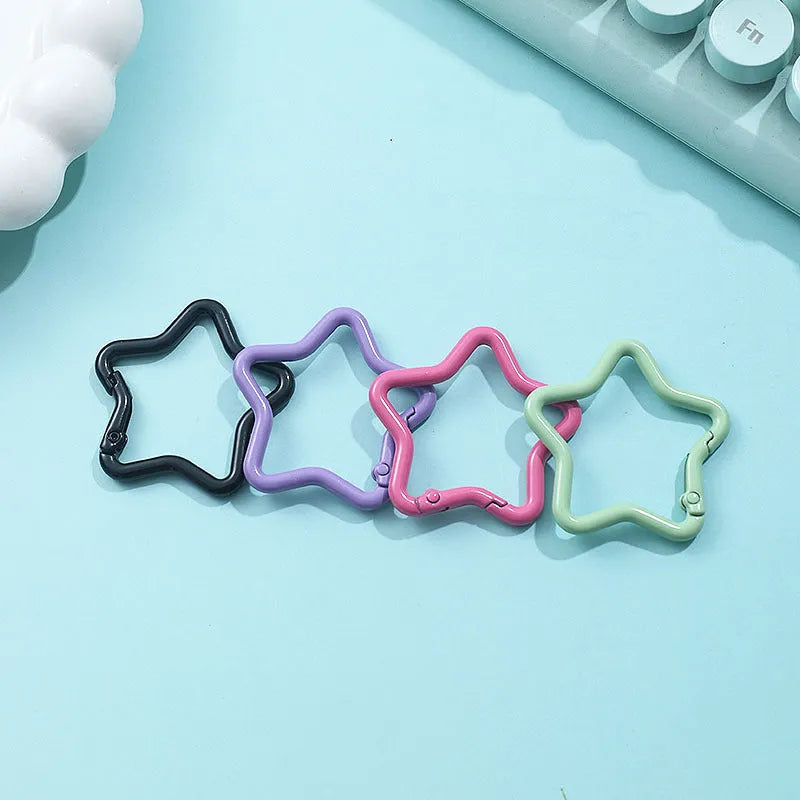 Zinc alloy five-pointed star keychain charm in multiple colour options on a keyring.