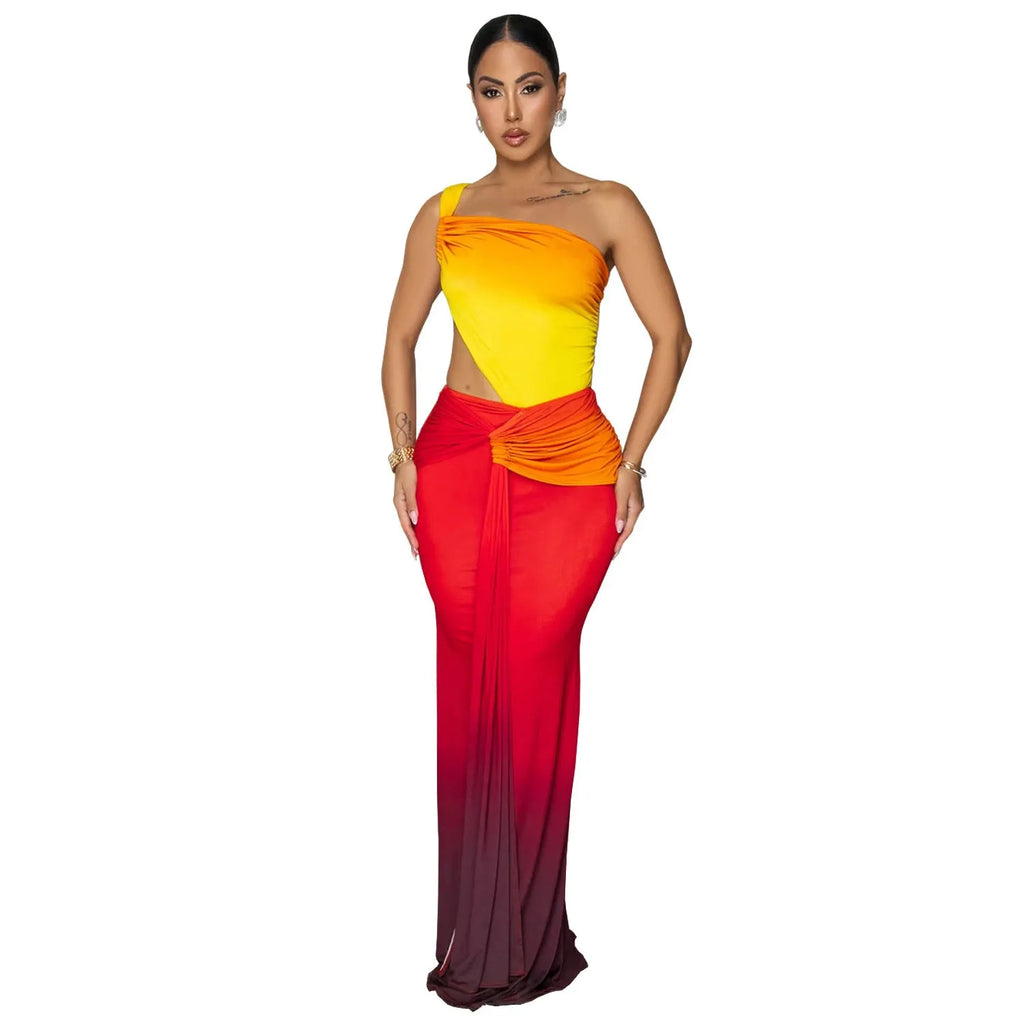 A woman wearing a long gradient colour dress with a cross-shoulder sleeveless design and a high waist.