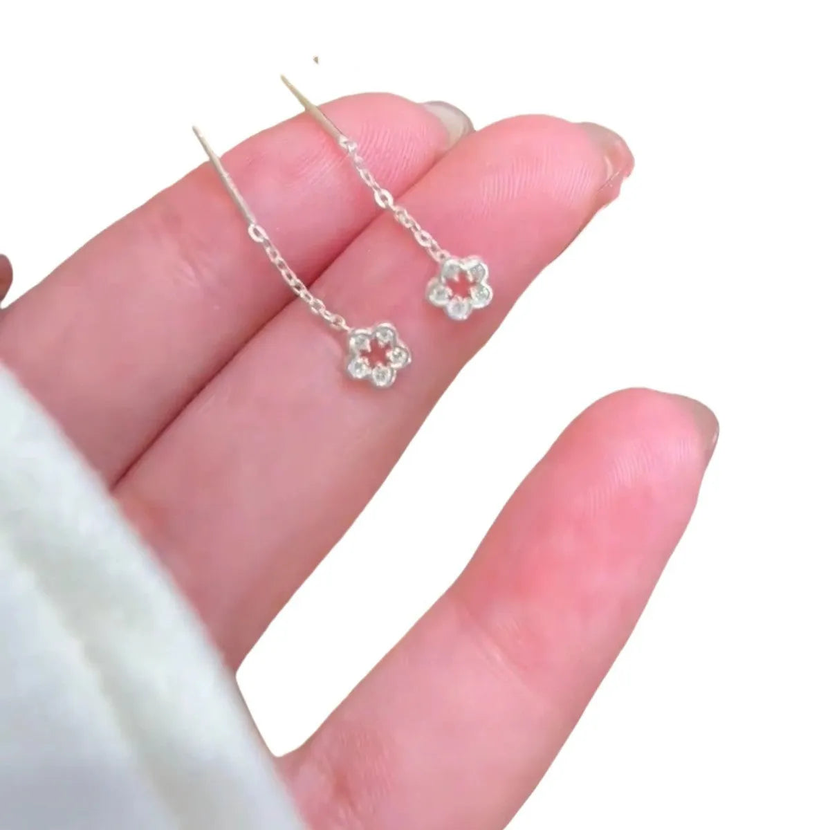 Sterling silver hollow flower drop earrings with petal design and hook fastening