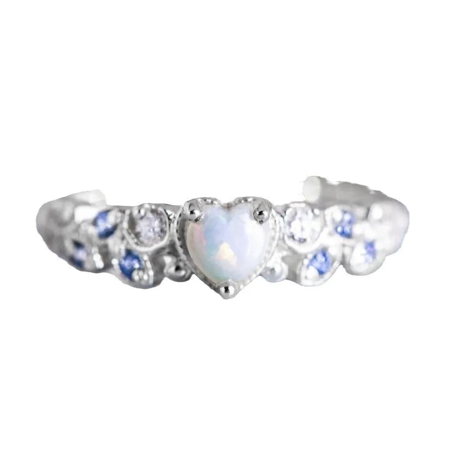 White alloy women's ring with a heart shape, floral detailing, and opalescent peach ocean design.