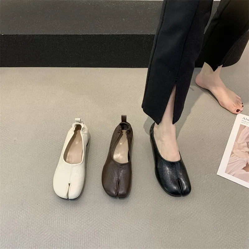 Women's round toe pumps with a split toe horseshoe design and a chunky low heel.