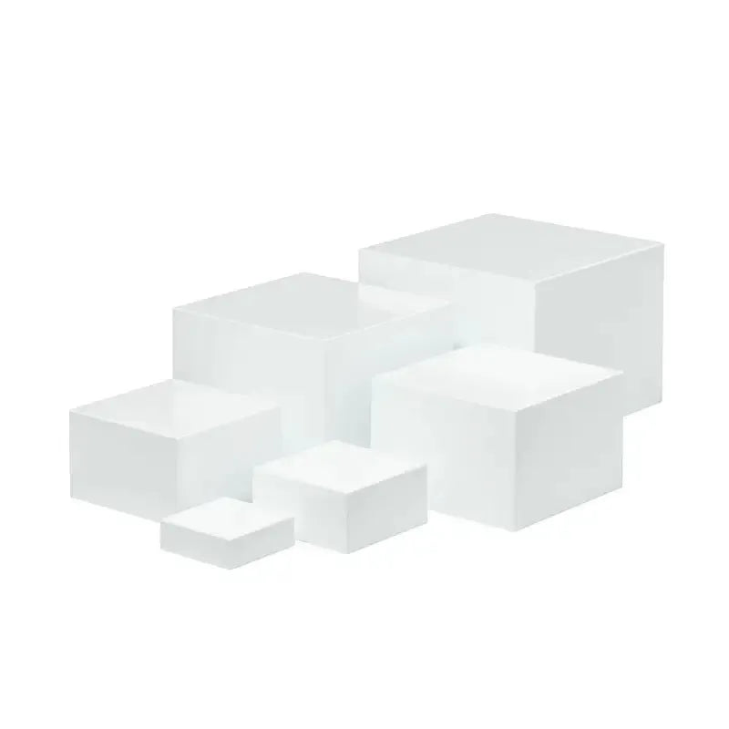 White and clear plastic modular six-piece suit cube dessert display stand on a desktop.