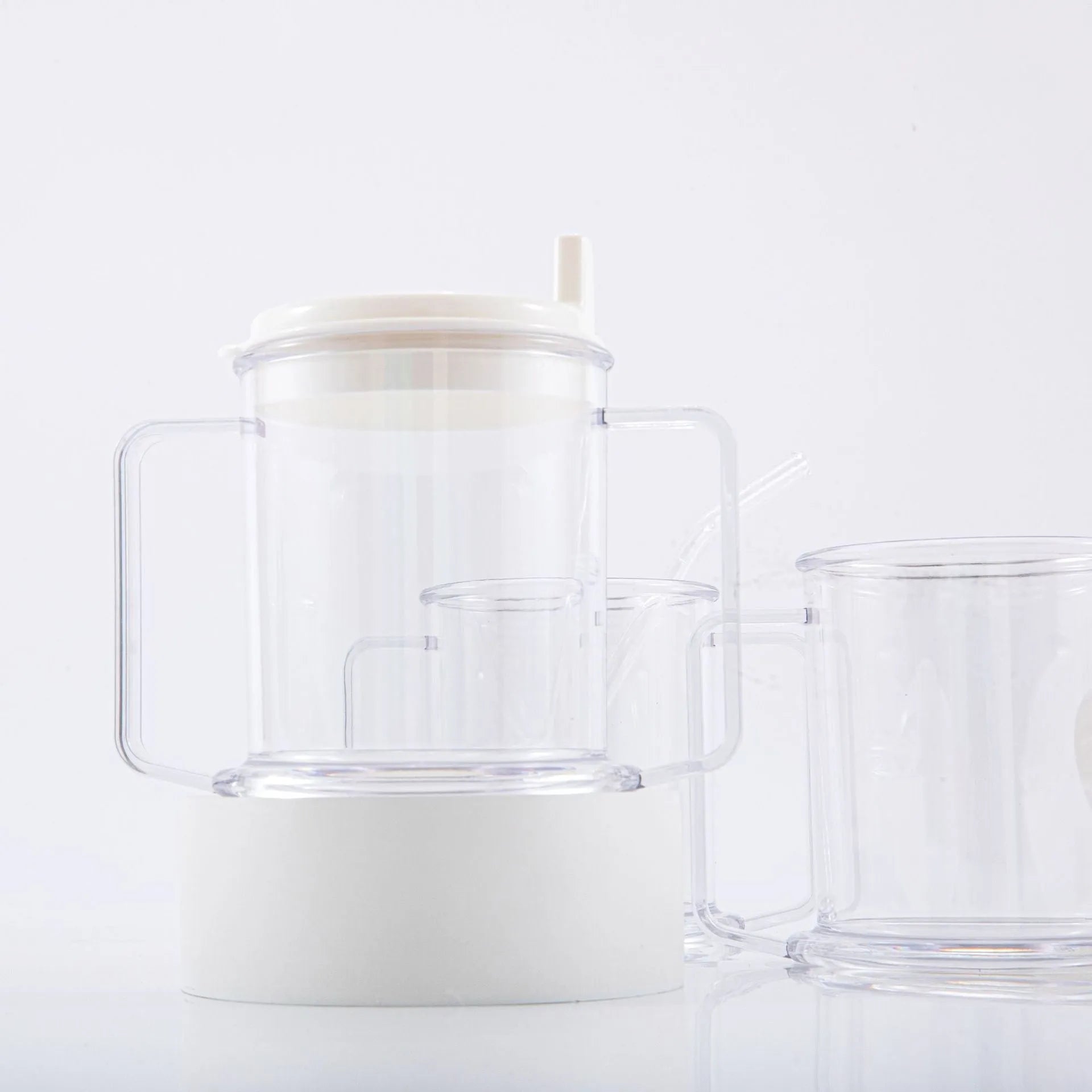Transparent plastic spill-proof drinking cup showing 14cm height and 12cm brim.