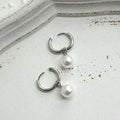Geometric pearl drop earrings with round elements made from titanium steel alloy