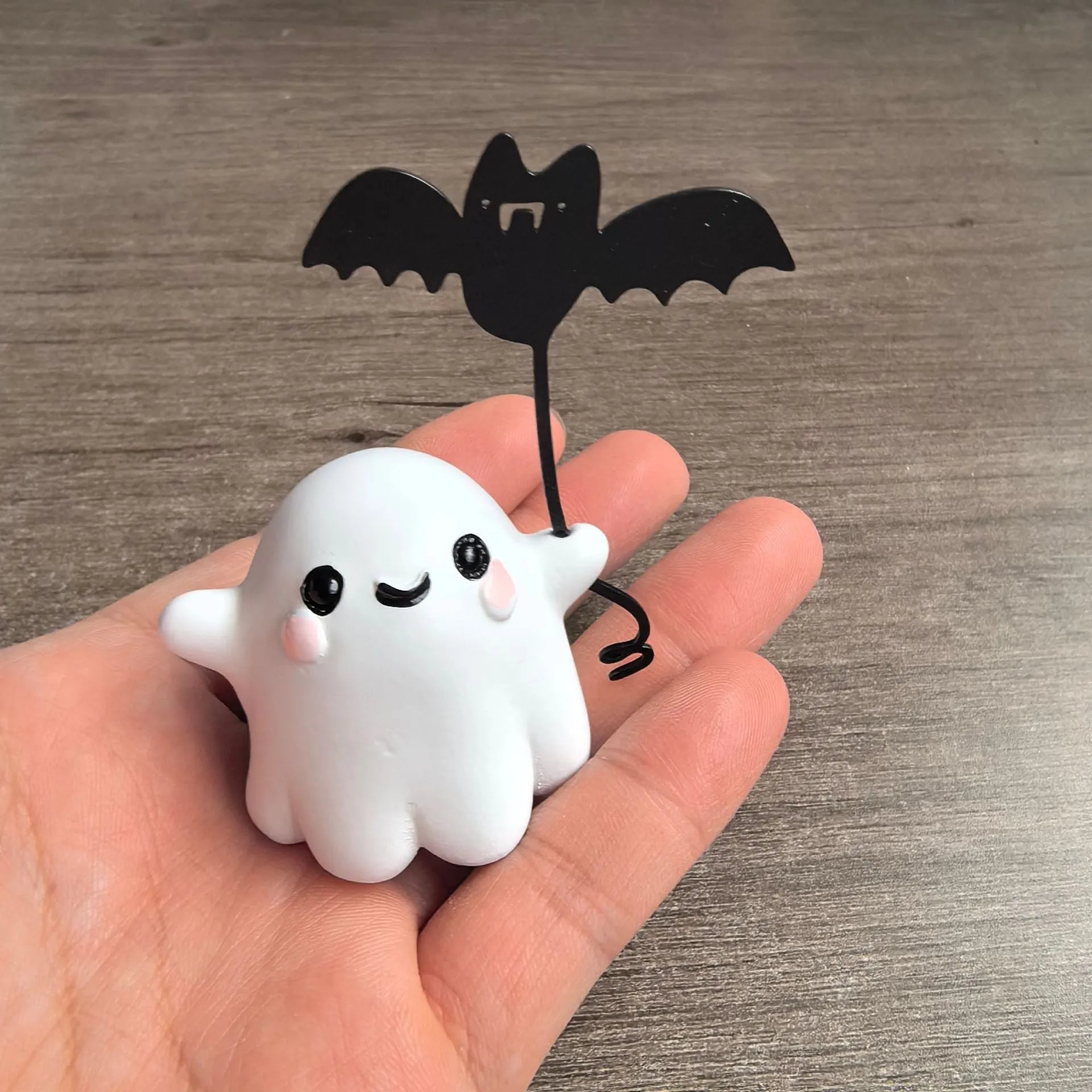 Miniature resin statue of a ghost walking a dog, Halloween decoration measuring 4x5x4cm.