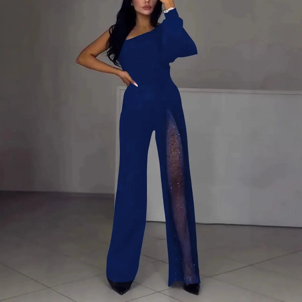 Women's black oblique shoulder jumpsuit with high slit and long sleeves.