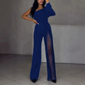 Women's black oblique shoulder jumpsuit with high slit and long sleeves.