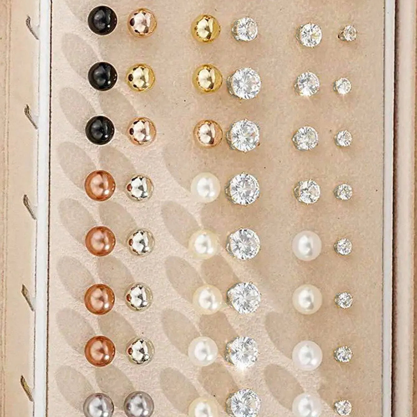 108 gold and yellow geometric round pearl earrings spread out, showing electroplated alloy construction.