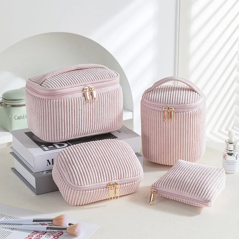 Four cube-shaped makeup bags in matching colour sets for travel cosmetic organisation