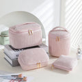 Four cube-shaped makeup bags in matching colour sets for travel cosmetic organisation