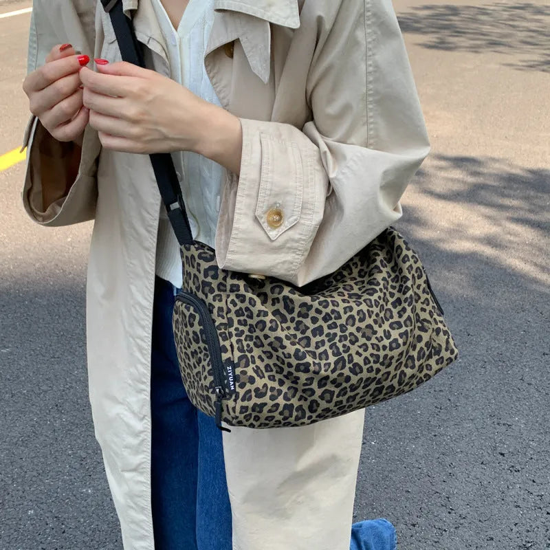 Large capacity leopard print sports style shoulder messenger bag with cloth construction and stitching details